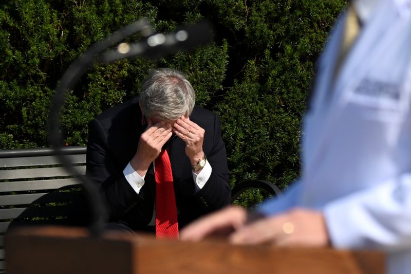 © Reuters. White House Chief of Staff Mark Meadows rubs his head as U.S. Navy Commander Dr. Sean Conley speaks about U.S. President Donald Trump's health, in Bethesda