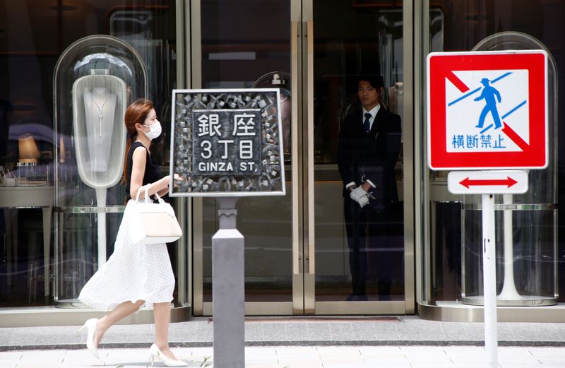 &copy; Reuters. A woman walks past a luxury brand shop at a shopping district in Tokyo