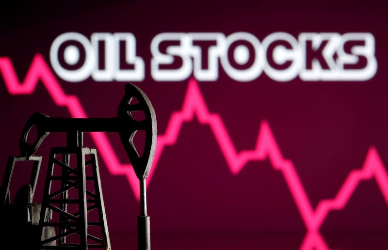 © Reuters. A 3D printed oil pump jack is seen in front of displayed stock graph and 