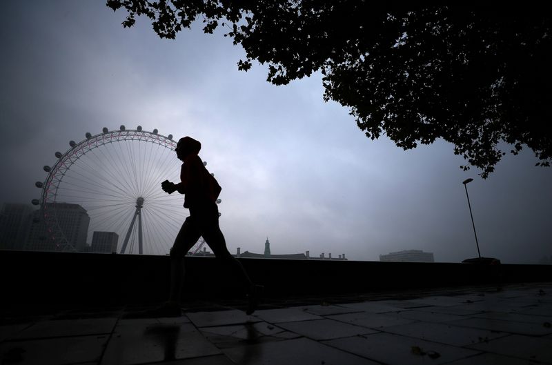 &copy; Reuters. A person runs past the London Eye in London