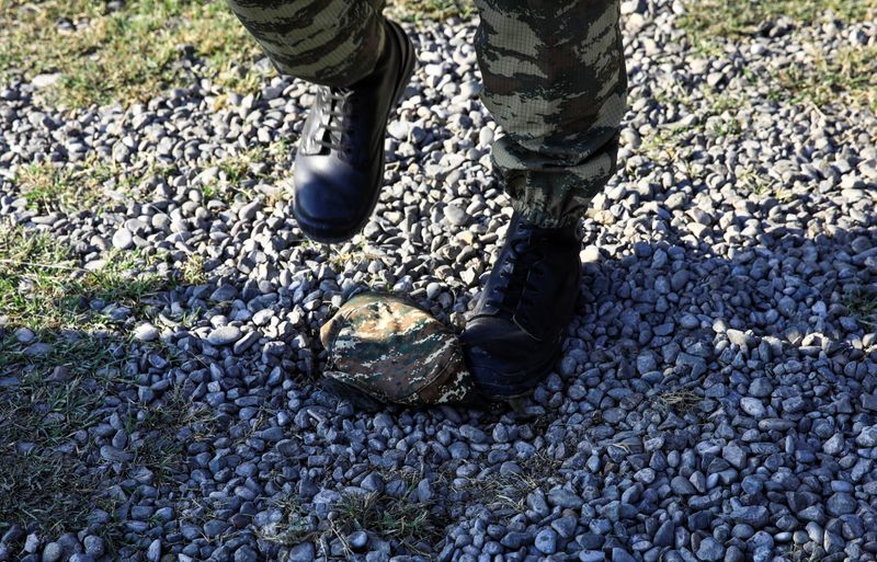 &copy; Reuters. A soldier steps on an Armenian army hat found in a damaged Armenian military truck seized by Azerbaijan army during the fighting over the breakaway region of Nagorno-Karabakh near the city of Barda