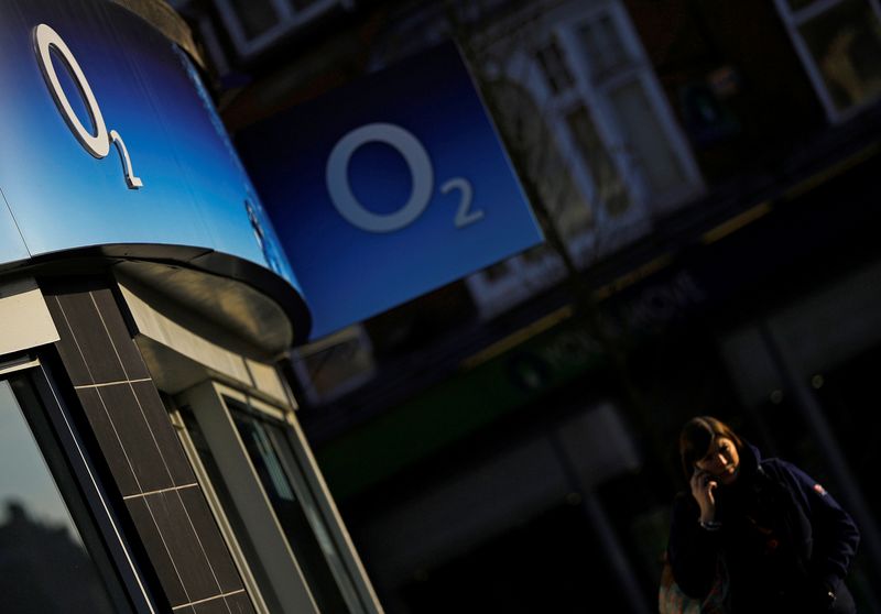 &copy; Reuters. A woman speaks on her mobile telephone outside an O2 shop in Loughborough