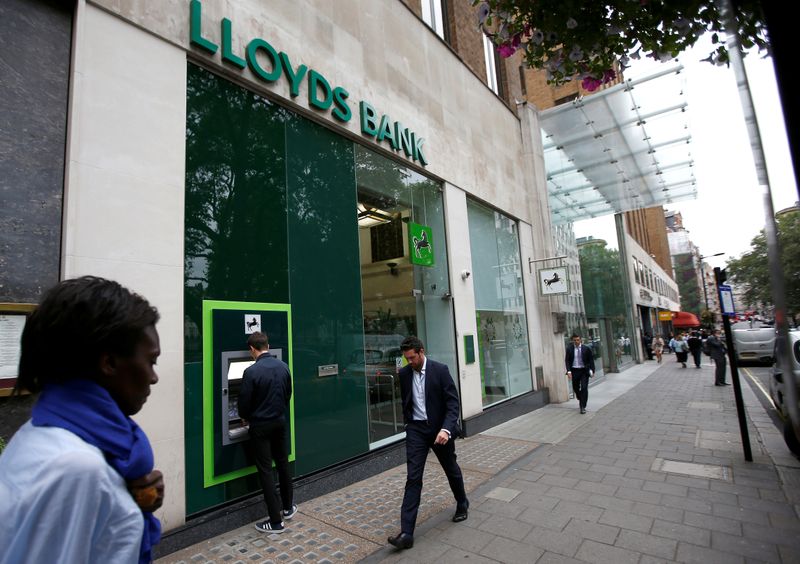 &copy; Reuters. FILE PHOTO: People walk past a branch of Lloyds Bank at Berkeley Square in London