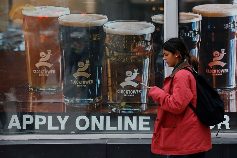 © Reuters. A sign advertising available jobs at the Clocktower Brew Pub hangs in a window in Ottawa