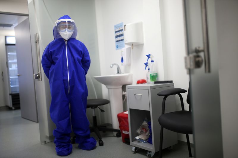 &copy; Reuters. FILE PHOTO: A nurse wearing protective gear is seen inside a coronavirus disease (COVID-19) sampling room of the Synlab laboratory, at El Dorado airport in Bogota