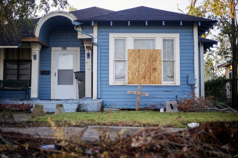 &copy; Reuters. A house with a boarded up window is seen after Hurricane Delta in Lake Charles