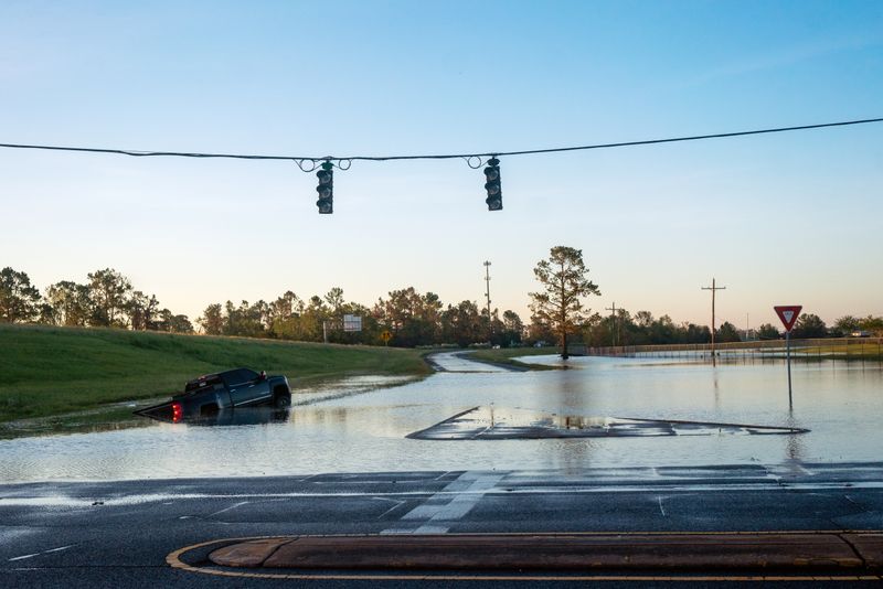 &copy; Reuters. A submerged car is pictured on a flooded street after Hurricane Delta in Lake Charles