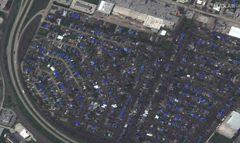© Reuters. A satellite image shows damaged roofs and blue tarps near Interstate 210 and Highway 14 (LA 14) after Hurricane Delta in Lake Charles