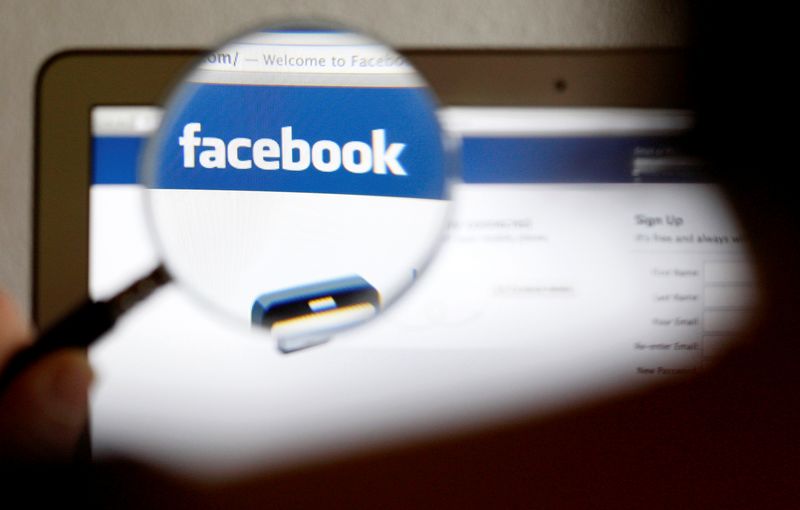 &copy; Reuters. FILE PHOTO: In this photo illustration, a Facebook logo on a computer screen is seen through a magnifying glass held by a woman in Bern