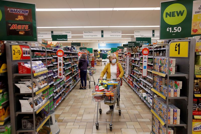 &copy; Reuters. FILE PHOTO: A customer wearing a protective face mask shops at a Morrisons store in St Albans