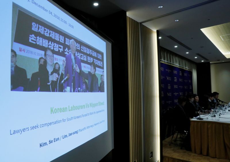 &copy; Reuters. FILE PHOTO: A projection shows an image of a plaintiff who was forced to work for Japanese firms during World War Two and seeks compensation during a news conference in Tokyo