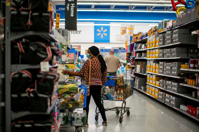 © Reuters. FILE PHOTO: A shopper is seen wearing a mask while shopping at a Walmart store, in North Brunswick, New Jersey