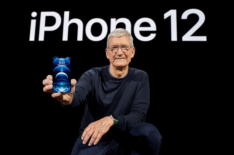 &copy; Reuters. Apple CEO Tim Cook poses with the all-new iPhone 12 Pro at Apple Park in Cupertino