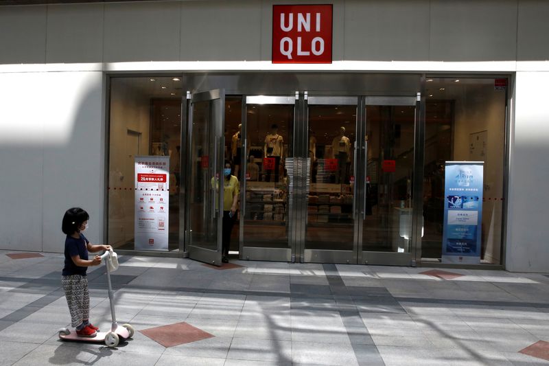 &copy; Reuters. Woman walks out of a Uniqlo store in Beijing
