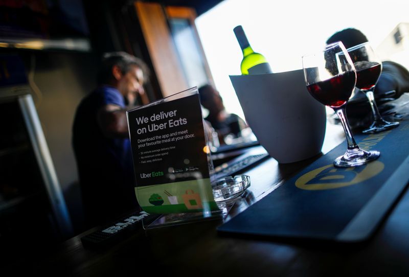 © Reuters. FILE PHOTO: A flyer advertising Uber Eats delivery service is pictured at a restaurant in Cape Town