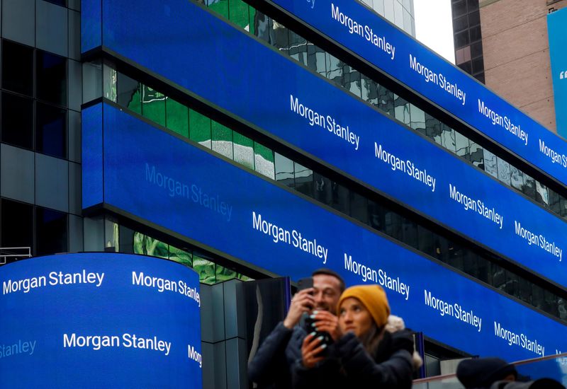 © Reuters. FILE PHOTO: People take photos by the Morgan Stanley building in Times Square in New York