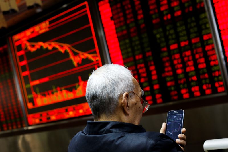 &copy; Reuters. An investor sits in front of a board showing stock information at a brokerage office in Beijing