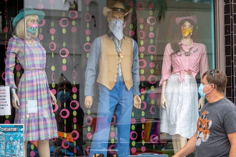 &copy; Reuters. FILE PHOTO: A man wears a mask as he walks through a retail shopping area during the outbreak of the coronavirus disease in California