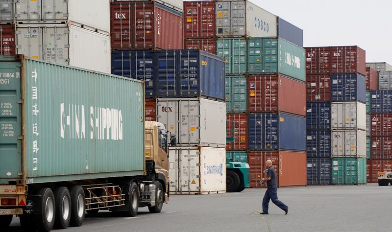 © Reuters. A laborer works in a container area at a port in Tokyo