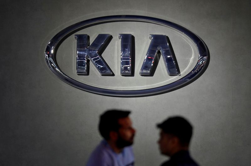 &copy; Reuters. FILE PHOTO: Visitors walk past the logo of Kia Motors at its pavilion at the India Auto Expo 2020 in Greater Noida