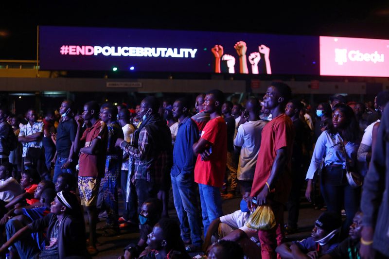 &copy; Reuters. Demonstrators gather beside an electronic billboard displaying the slogan &quot;End police brutality&quot;, during a protest in Lagos