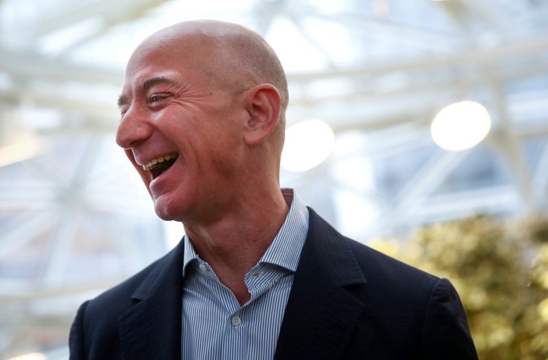 &copy; Reuters. FILE PHOTO: Amazon founder and CEO Jeff Bezos laughs as he talks to the media while touring the new Amazon Spheres during the grand opening in Seattle