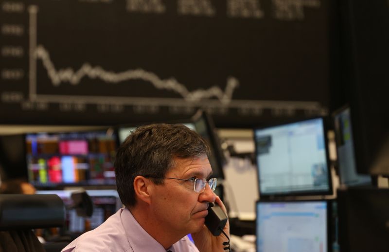 &copy; Reuters. A stock trader looks at his screens during a trading session at Frankfurt&apos;s stock exchange as markets react on the coronavirus disease (COVID-19) in Frankfurt