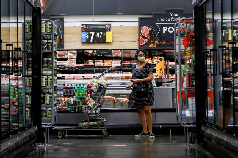 &copy; Reuters. FILE PHOTO: A shopper is seen wearing a mask while shopping at a Walmart store in Bradford, Pennsylvania