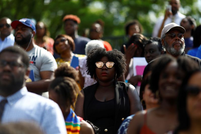 &copy; Reuters. FILE PHOTO: People watch as Actor Chadwick Boseman addresses the 150th commencement ceremony at Howard University in Washington
