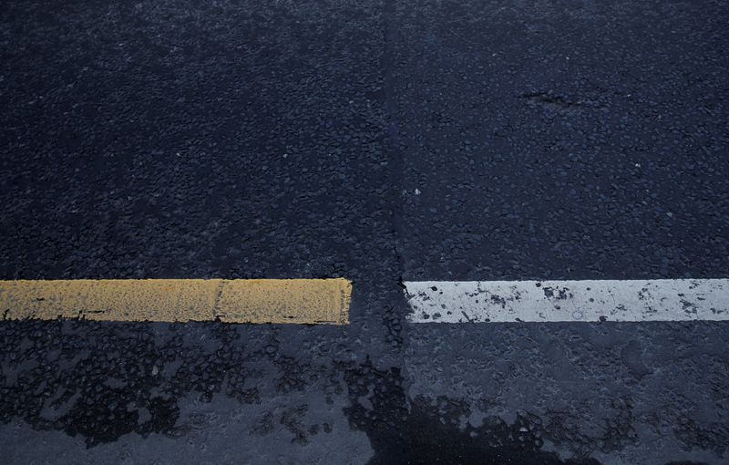 &copy; Reuters. FILE PHOTO: Different coloured road markings and a line in the tarmac mark the border between Ireland and Northern Ireland in Bridgend Northern Ireland