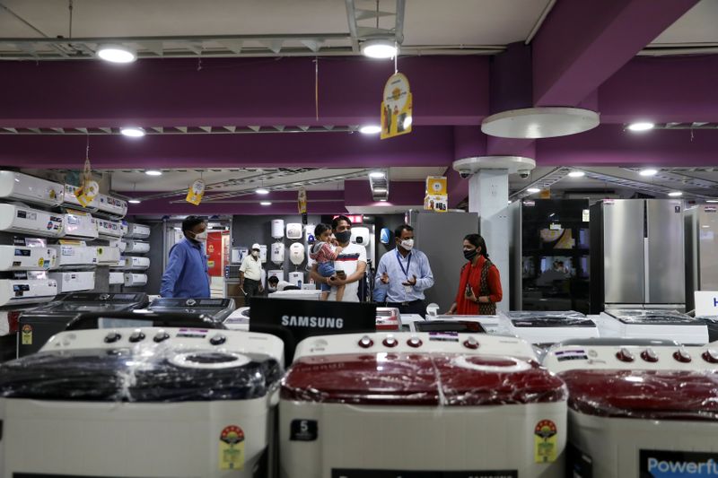 &copy; Reuters. A customer with his family is seen at an electronics and appliances shop in Jaipur