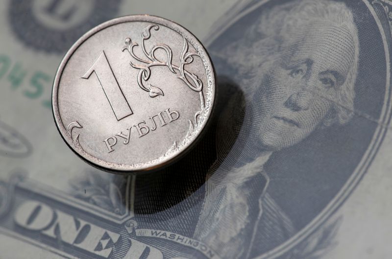 &copy; Reuters. FILE PHOTO:  A view shows a Russian rouble coin and a U.S. dollar banknote in this picture illustration