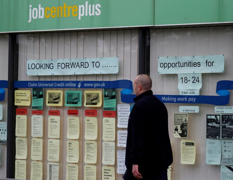 &copy; Reuters. FILE PHOTO: A man walks past a job centre following the outbreak of the coronavirus disease (COVID-19), in Manchester