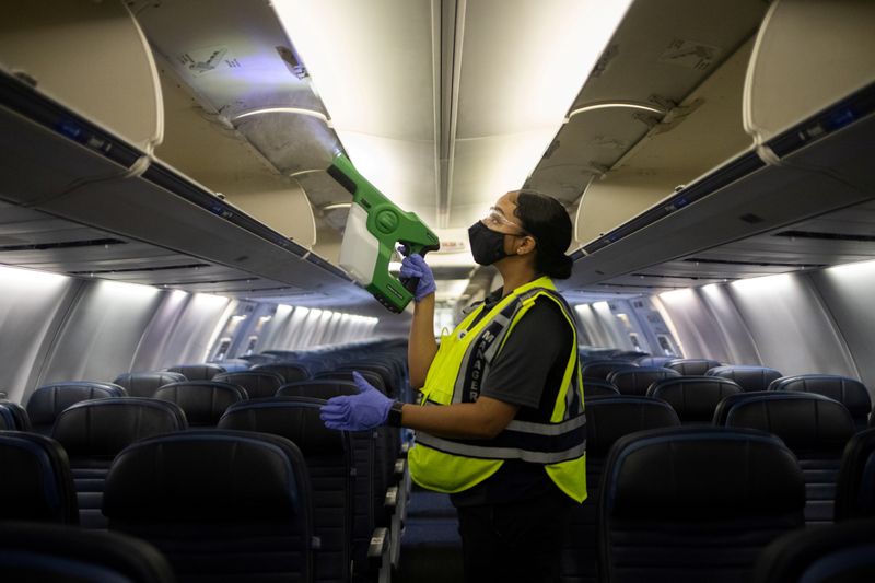 &copy; Reuters. FILE PHOTO: Worker demonstrates use of an electrostatic disinfectant sprayer on United Airlines plane at IAH George Bush Intercontinental Airport in Houston