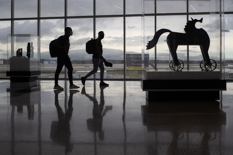&copy; Reuters. Passengers walk past artwork between terminals at IAH George Bush Intercontinental Airport in Houston