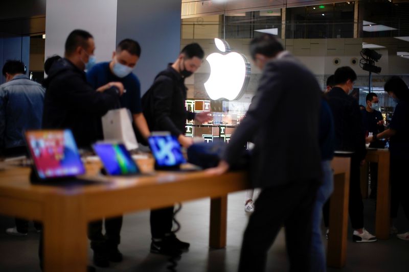 &copy; Reuters. People look at Apple products at an Apple Store, as the coronavirus disease (COVID-19) outbreak continues in Shanghai