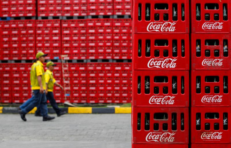 &copy; Reuters. FILE PHOTO: Workers walk at PT Coca-Cola Amatil Indonesia&apos;s factory in Cibitung