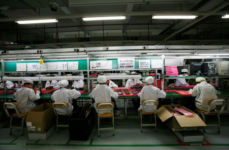 &copy; Reuters. FILE PHOTO: Workers are seen inside a Foxconn factory in the township of Longhua in the southern Guangdong province