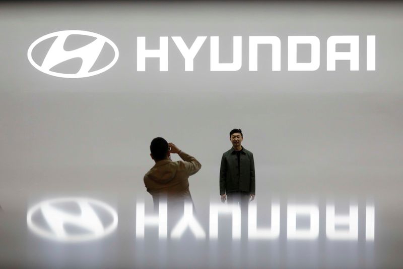 © Reuters. FILE PHOTO: Visitors take photographs in front of the logo of Hyundai Motor during the 2019 Seoul Motor Show in Goyang