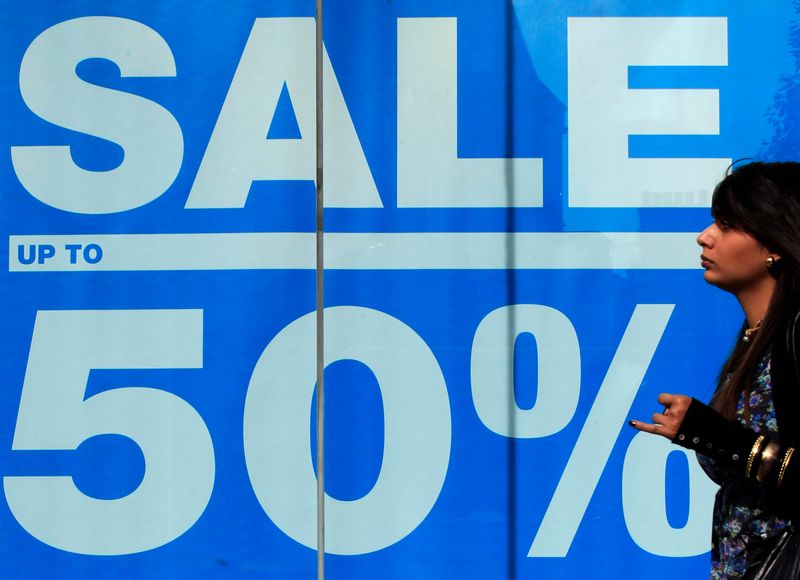 &copy; Reuters. A shopper passes an advertisement on a shop in Oxford Street in London