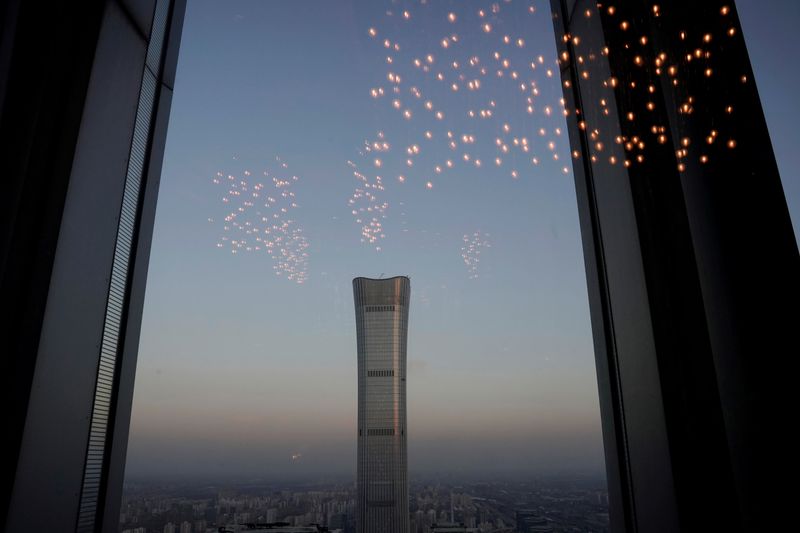 &copy; Reuters. FILE PHOTO: China Zun Tower under construction is seen through a window in Beijing&apos;s central business area