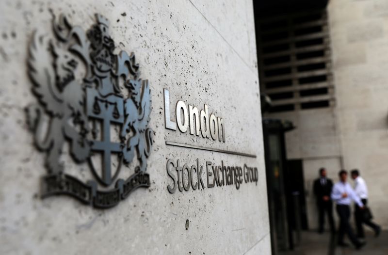 &copy; Reuters. FILE PHOTO:  Pedestrians leave and enter the London Stock Exchange in London