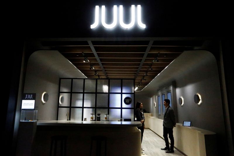 &copy; Reuters. Shopkeepers stand inside a Juul shop at a shopping mall in Jakarta