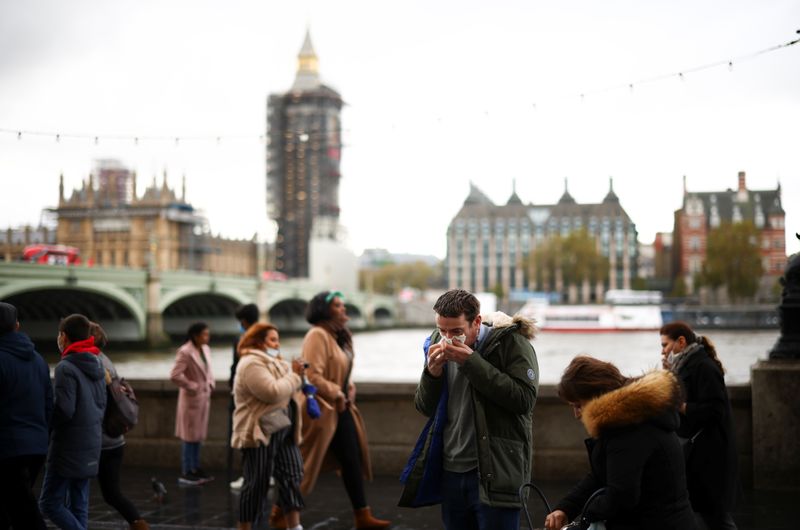 &copy; Reuters. A man blows his nose while on the South Bank, amid the coronavirus disease (COVID-19) outbreak, in London
