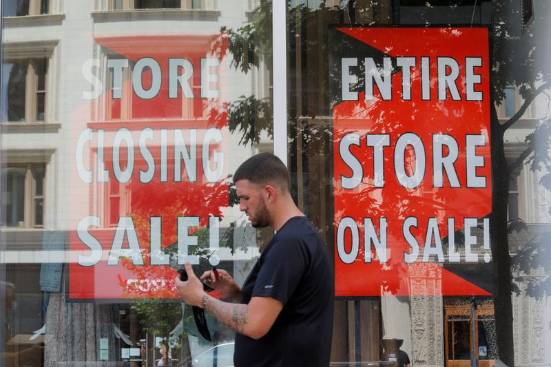 &copy; Reuters. FILE PHOTO: FILE PHOTO: A man walks past signs in the windows of Lord &amp; Taylor, advertising a store closing sale, in Boston