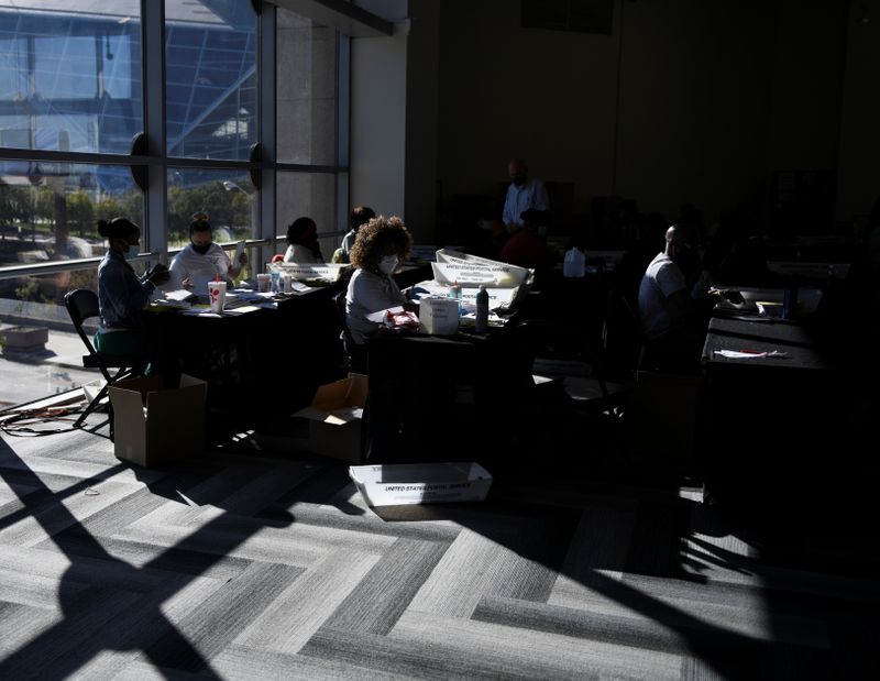 &copy; Reuters. Employees of the Fulton County Board of Registration and Elections process ballots in Atlanta