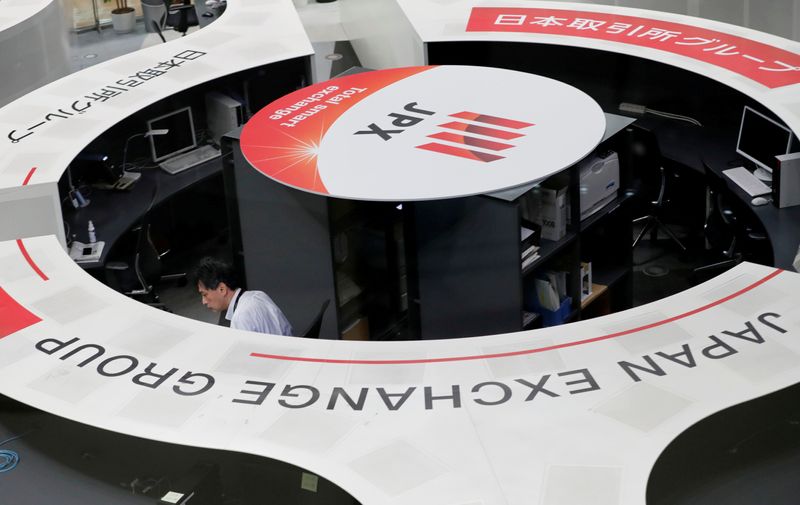 &copy; Reuters. FILE PHOTO: A man works at the Tokyo Stock Exchange after market opens in Tokyo