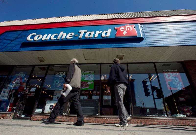 &copy; Reuters. Pedestrians walk past a Couche-Tard convenience store in Montreal