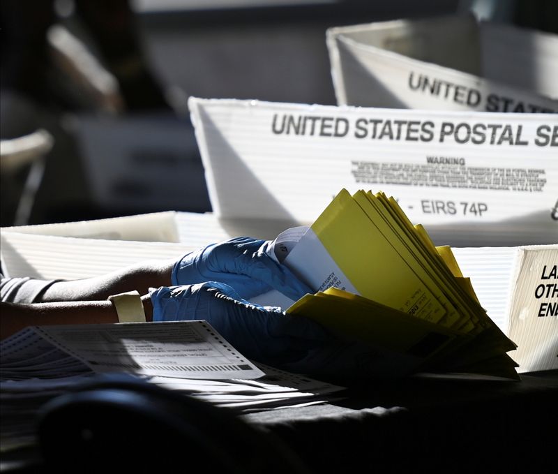 &copy; Reuters. Employees of the Fulton County Board of Registration and Elections process ballots in Atlanta