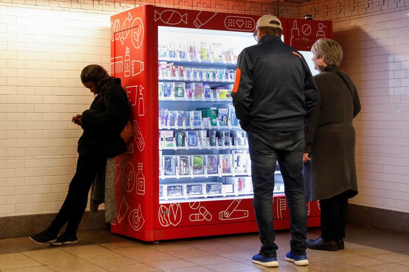 &copy; Reuters. People look at a CVS vending machine in a subway station in New York